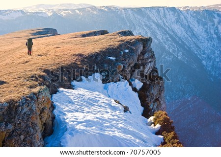 hiker near a mountain precipice