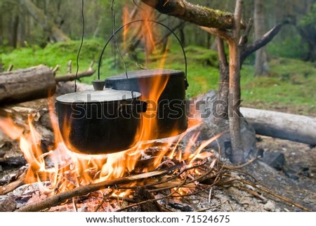 touristic campfire and two cauldrons