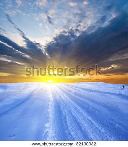 dramatic sunset in a winter plain