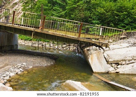 broken bridge on a mountain river