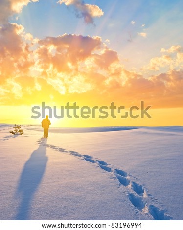 tourist in a winter plain at the evening
