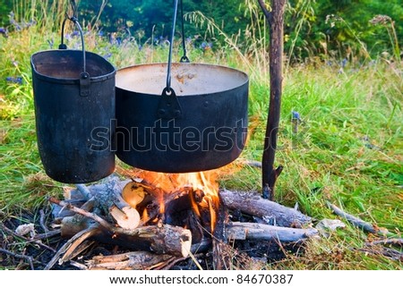 two touristic cauldron in a fire