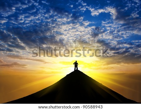 man silhouette stay on a mountain top