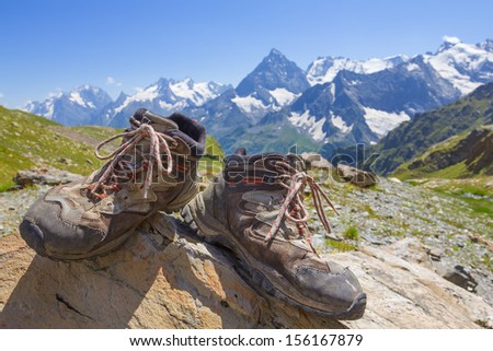 touristic boots on a mountain chain background