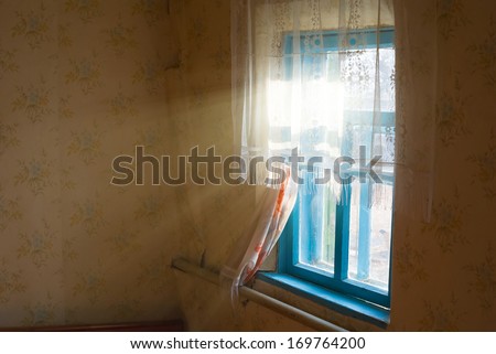 rays of sun pushing through a rural house window
