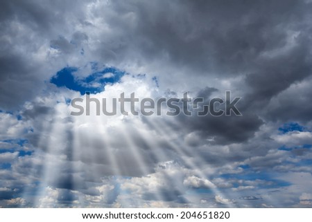 sun rays pushing through a clouds