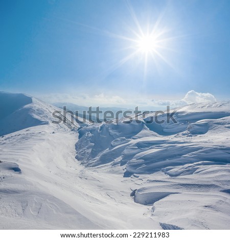 winter snowbound hills under a sparkle sun