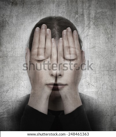 Woman covers her face with her hands. Surreal concept photo manipulation.