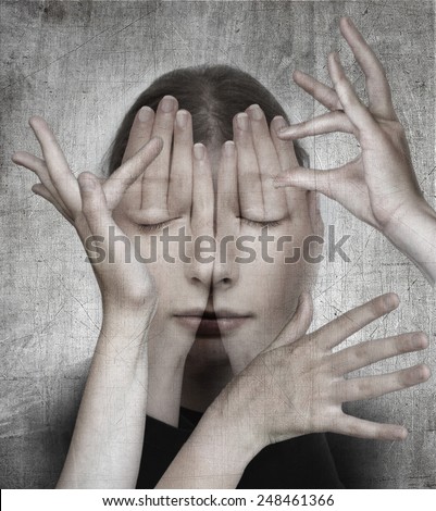 Woman with her hands on the grunge background.  Surreal concept photo manipulation