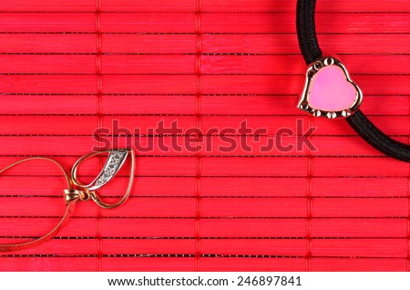 Orange gold-plated heart with gold heart on the red bamboo surface