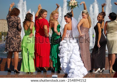 Moscow, Russia - September 22, 2007: The bride and her bridesmaids in colorful dresses photographed against the backdrop of fountains. \
Fountains are very popular in Moscow for weddings.