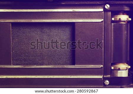 The back of the film dslr camera with the lid open. Shutter curtain and gear for the film. Close up view. Macro. Vintage photo. Toning.