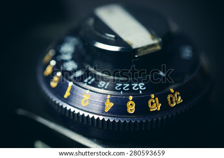 Old film DSLR camera. The dial sensitivity of the film. Rewinding the film. Close up view. Macro. Selective focus. Vintage photo. Toning.