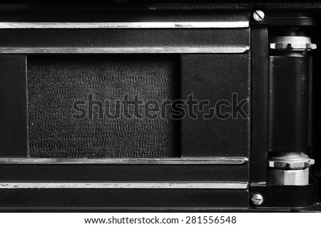 The back of the film dslr camera with the lid open. Shutter curtain and gear for the film. Close up view. Macro. Vintage photo. Black and white