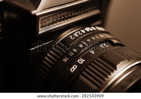 Old film DSLR camera with lens. The scale of the aperture, depth of field and distance. Close up view. Macro. Selective focus. Vintage photo. Toning.