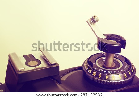 Old film DSLR camera. The dial sensitivity of the film. Rewinding the film. Index of the exposure meter. Close up view. Macro. Top view. Selective focus. Vintage photo. Toning.