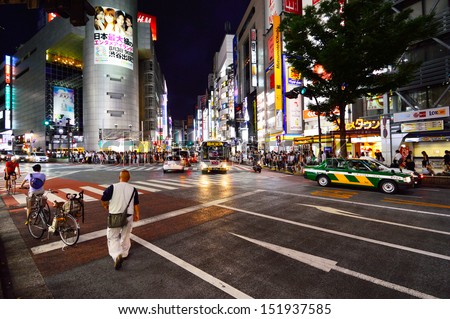 TOKYO, JAPAN - AUGUST 3: Crowds of people crossing the center of Shibuya in August 3 2013, the most important commercial center in Tokyo, Japan