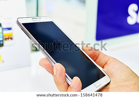 SAIGON, VIETNAM - OCTOBER 8 : Hand holding the Samsung Galaxy Note 3, is an Android phablet smartphone produced by Samsung Electronics and runs Android 4.3 in October 8, 2013