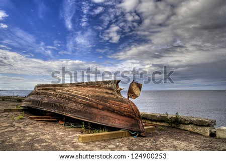 Rusty boat turned upside down on seaside