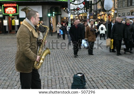 Man playing saxophone a shoppingstreet in Copenhagen, Denmark