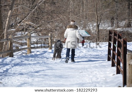 Lady and her dog walking during winter