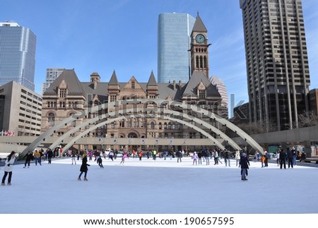 Toronto, Canada - March 10, 2014: Torontonians and tourists are enjoying the outdoor skating rink in Nathan Phillips Square.
