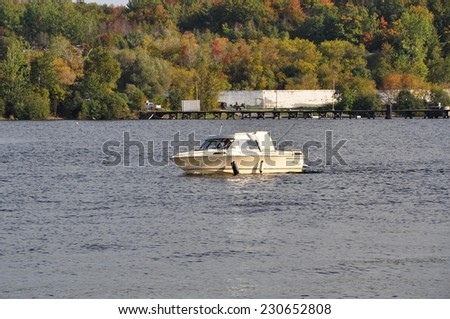 Parry Sound, Ontario, Canada - September 29, 2014: Sailboat returning in Parry Sound downtown harbour.