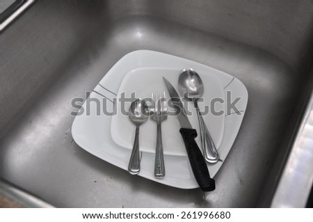 Used plates and utensils in the sink