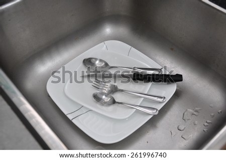 Soiled plates and utensils in sink