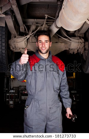 Truck mechanic thumbs up.