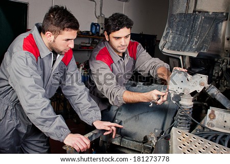 Mechanics at work on a truck.