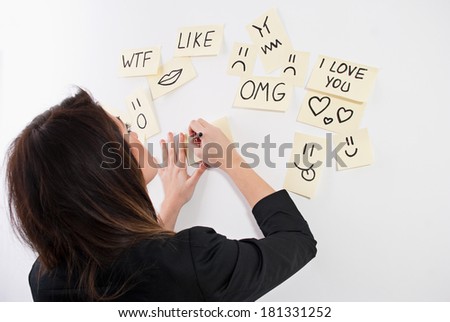 Girl writing on sticky notes.