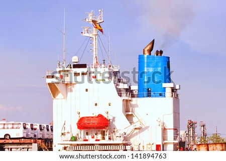 Large container cargo ship and support tug boat