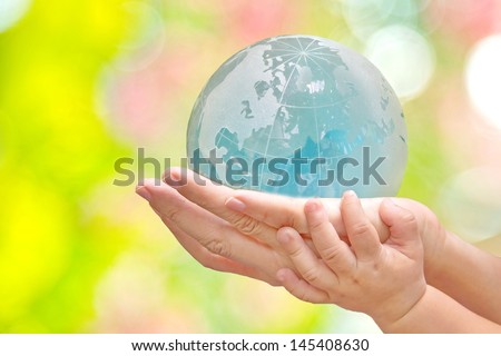 Hand of baby and young holding the Earth isolated America on bokeh background