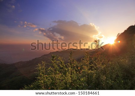 The Mountain twilight sky power full color with fresh flower people clapping long week end at Phutabberg in Thailand.