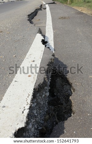 cracked asphalt road after flood