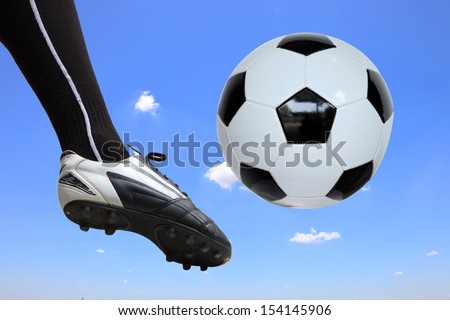 soccer player doing flying kick with ball