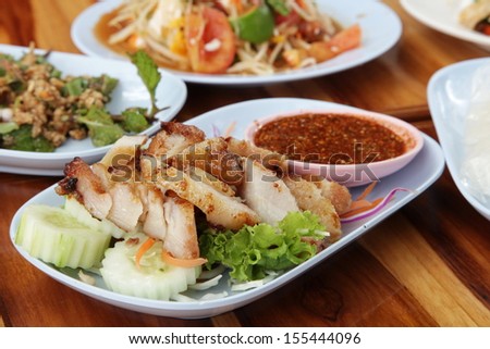 Grilled pork slices on a plate and served with dipping sauce will taste very good, you will get fat from fat in meat.