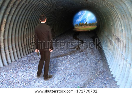 Businessman standing in front of the entrance tunnel, dark gaze commitment to the tunnel with a bright, richly. Make difficult decisions Achieving success requires planning problem.