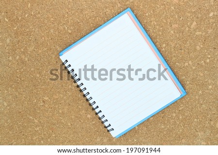 blank realistic spiral notepad notebook isolated on Cork board background