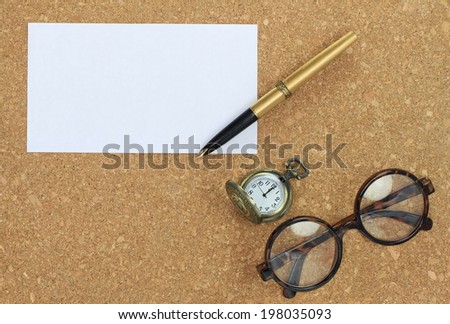 Blank notepad paper, business cards and pen and New Year\'s clock at on cork wood
