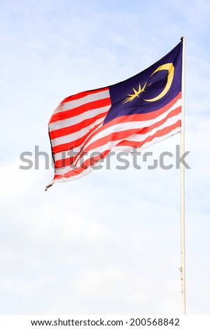 Malaysia flag waving on the wind flew over the blue sky Malaysia flag waving on the wind flew over the blue sky