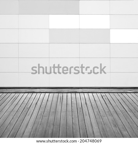 Grunge brick wall and wooden floor inside room.