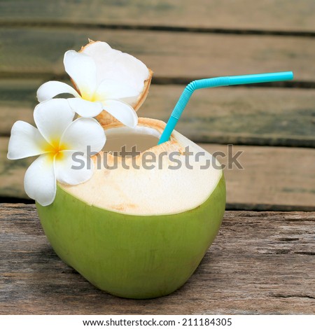Coconut Water Drink, beach cafe, plumeria on table with blurry background