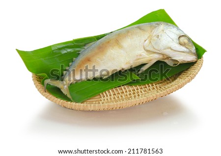 steamed boiled mackerel on banana leave in bamboo wood basket ready for cook one of the most favorite healthy food in South East Asia style. This was isolated on white background with clipping path.