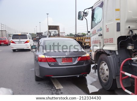 BANGKOK, THAILAND - AUGUST 21: Rescue forces in a deadly car accident scene on August 2014. Road accident new coupe gray hit the truck car kiss bottom on the freeway in rush hour.