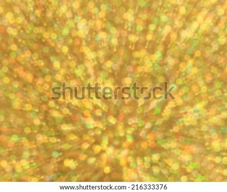 Gold abstract explosion with glitter zoom bokeh lights background.