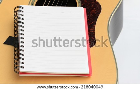 blank realistic spiral notepad notebook isolated on wood guitar board background
