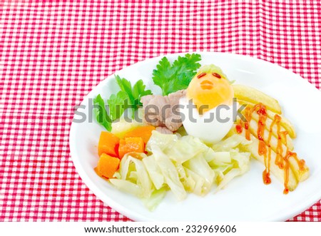 Breakfast for children to dress up as a cartoon with boiled eggs, fried potatoes, carrots, boiled with pork fried Lettuce and cabbage.