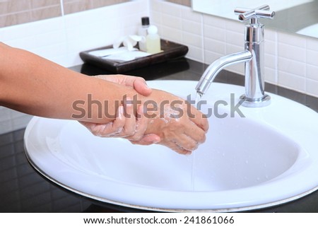 Medical wash hand cleaning with soap in the basin.
